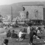 People in Skopje sitting on the streets looking at the damage the 1963 earthquake caused to the city.