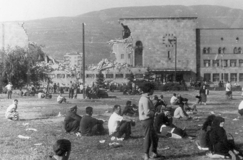 People in Skopje sitting on the streets looking at the damage the 1963 earthquake caused to the city.
